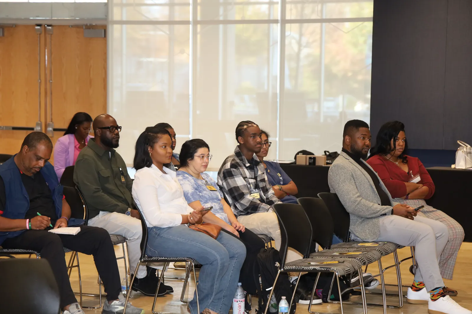 An audience listening closely during a community talk