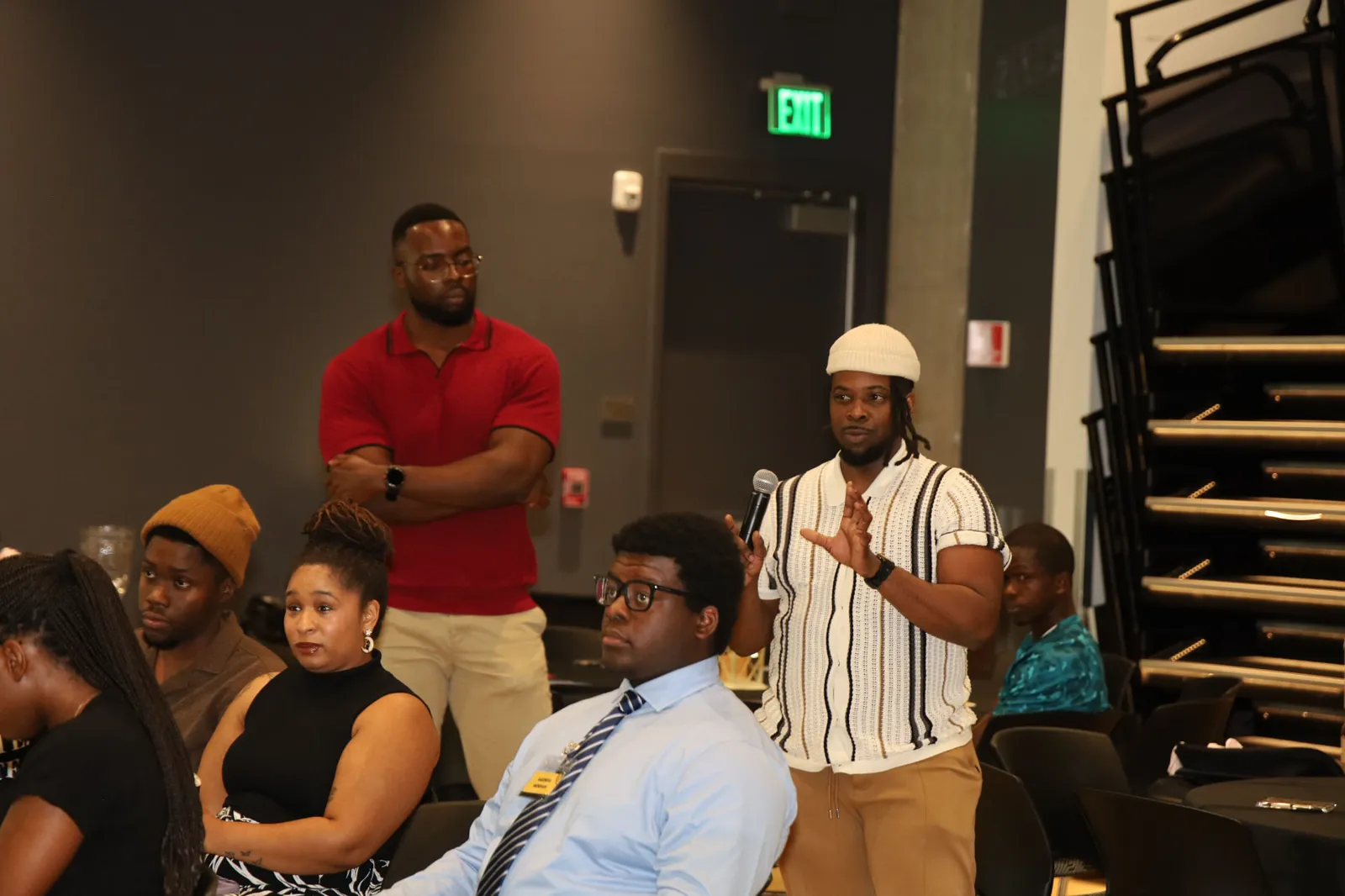 An attendee asking the speakers a question by microphone